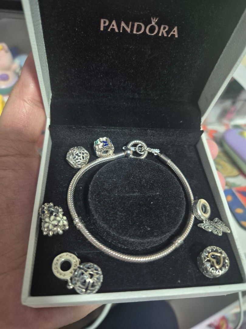 Pandora Charm Bracelet with Multiple Charms in Box (Category: Bracelets) located in Cainta. Submitted by mintandcinnamon (Listing ID 1464887454, Image 2). Description: - Authentic Pandora snake chain bracelet set 19cm - Includes original white storage box with velvet-lined slot - with 2 dangling charms, 2 regular charms, 2 spacers and 1 spacer/lock.