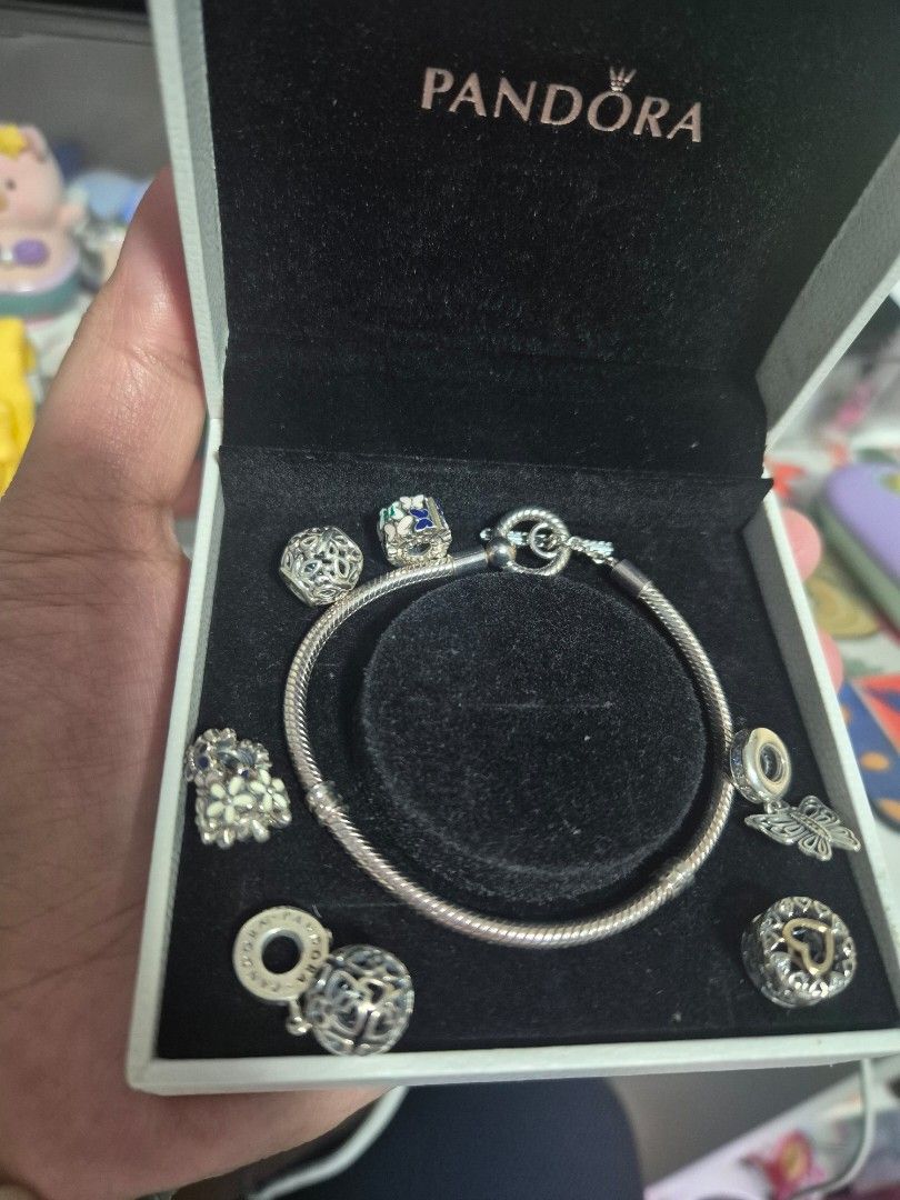 Pandora Charm Bracelet with Multiple Charms in Box (Category: Bracelets) located in Cainta. Submitted by mintandcinnamon (Listing ID 1464887454, Image 1). Description: - Authentic Pandora snake chain bracelet set 19cm - Includes original white storage box with velvet-lined slot - with 2 dangling charms, 2 regular charms, 2 spacers and 1 spacer/lock.