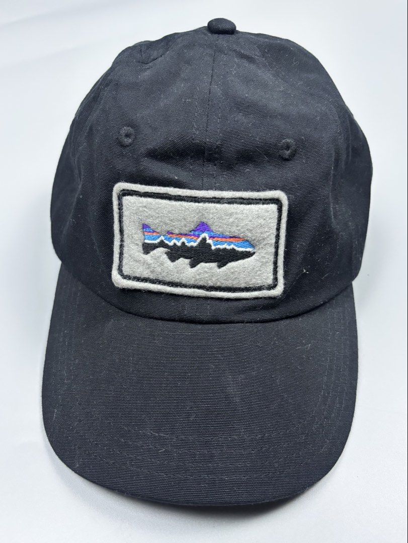 Patagonia Trout Patch Organic Cotton Cap (Category: Caps & Hats) located in Mabalacat. Submitted by doughnutthrift (Listing ID 1464928733, Image 2). Description: - Brand: Patagonia - Color: Classic black - Design: Embroidered trout patch with colorful stripe details - Material: 100% organic cotton - Fit: Adjustable strap closure at the back - Size: ALL (Worn Wear tag) - Origin: Made in China - Condition: Excellent, pre-loved/Worn Wear.