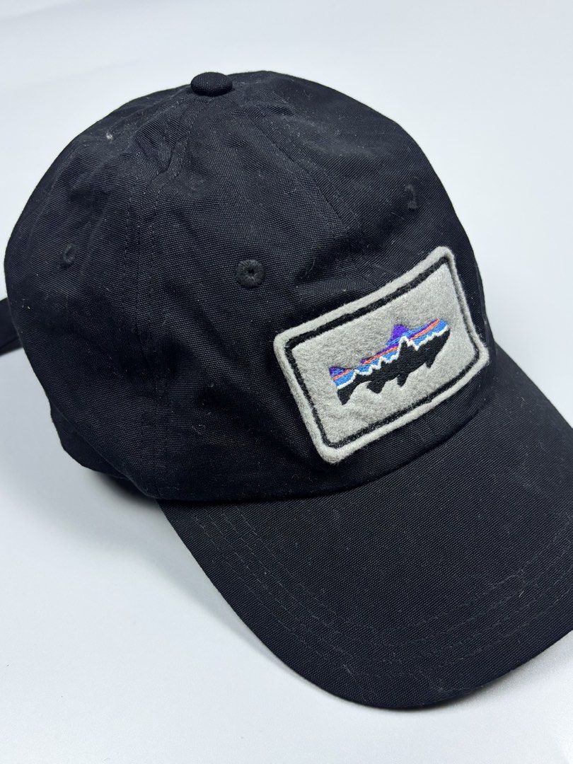 Patagonia Trout Patch Organic Cotton Cap (Category: Caps & Hats) located in Mabalacat. Submitted by doughnutthrift (Listing ID 1464928733, Image 3). Description: - Brand: Patagonia - Color: Classic black - Design: Embroidered trout patch with colorful stripe details - Material: 100% organic cotton - Fit: Adjustable strap closure at the back - Size: ALL (Worn Wear tag) - Origin: Made in China - Condition: Excellent, pre-loved/Worn Wear.