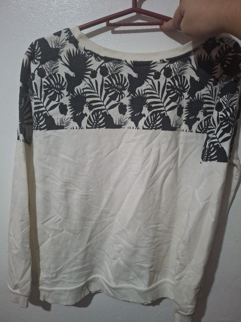 Penshoppe Tropical Leaf Print Sweatshirt Size M (Category: Coats, Jackets and Outerwear) located in Quezon City. Submitted by 042361 (Listing ID 1464802903, Image 2). Description: - Brand: Penshoppe - Size: Medium - Color/Design: White base with a black tropical leaf pattern block and matching chest pocket - Detail: "Sea you soon" text printed on the pocket - Material: Soft cotton blend - Features: Ribbed collar, cuffs, and hem - Condition: Clean