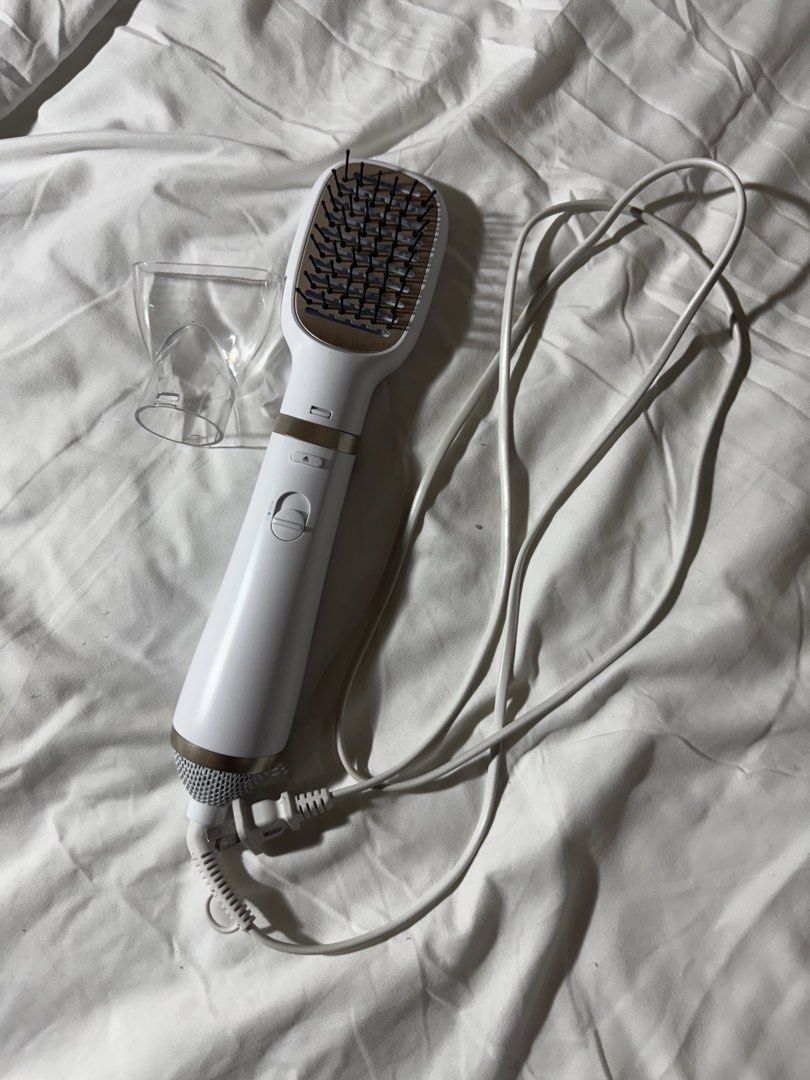 Philips EssentialCare Heated Styling Brush With Attachments (Category: Hair) located in Bacolod City. Submitted by lovedandprelovedbygee (Listing ID 1464845270, Image 1). Description: - Brand: Philips EssentialCare Styling Brush - Color: White with stylish gold accents - Dual Function: Dries and smooths hair simultaneously - Attachments: Includes interchangeable paddle brush and narrow concentrator nozzle - Settings: Convenient multi-speed switch