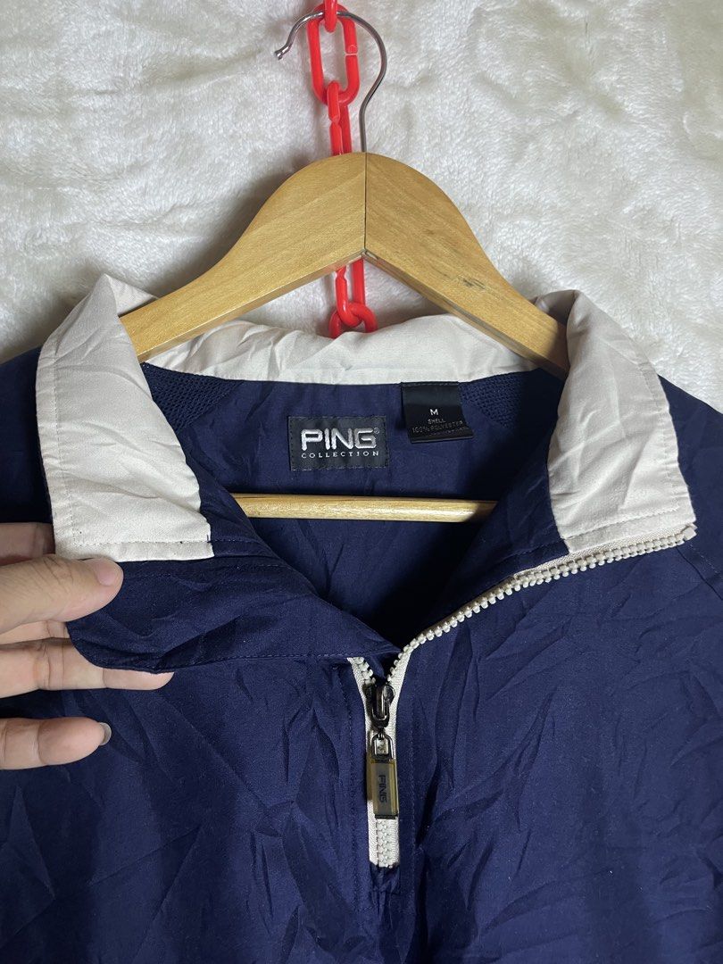 Ping Collection Navy Blue Windbreaker Jacket Size M (Category: Coats, Jackets and Outerwear) located in Molave. Submitted by charlesthrifter (Listing ID 1464895784, Image 2). Description: - Brand: Ping Collection - Color: Navy blue with white collar and side panel details - Size: Medium (M) - Material: 100% polyester shell (lightweight) - Features: Half-zip front closure with branded zipper pull and embroidered logo on the right sleeve - Ideal fo