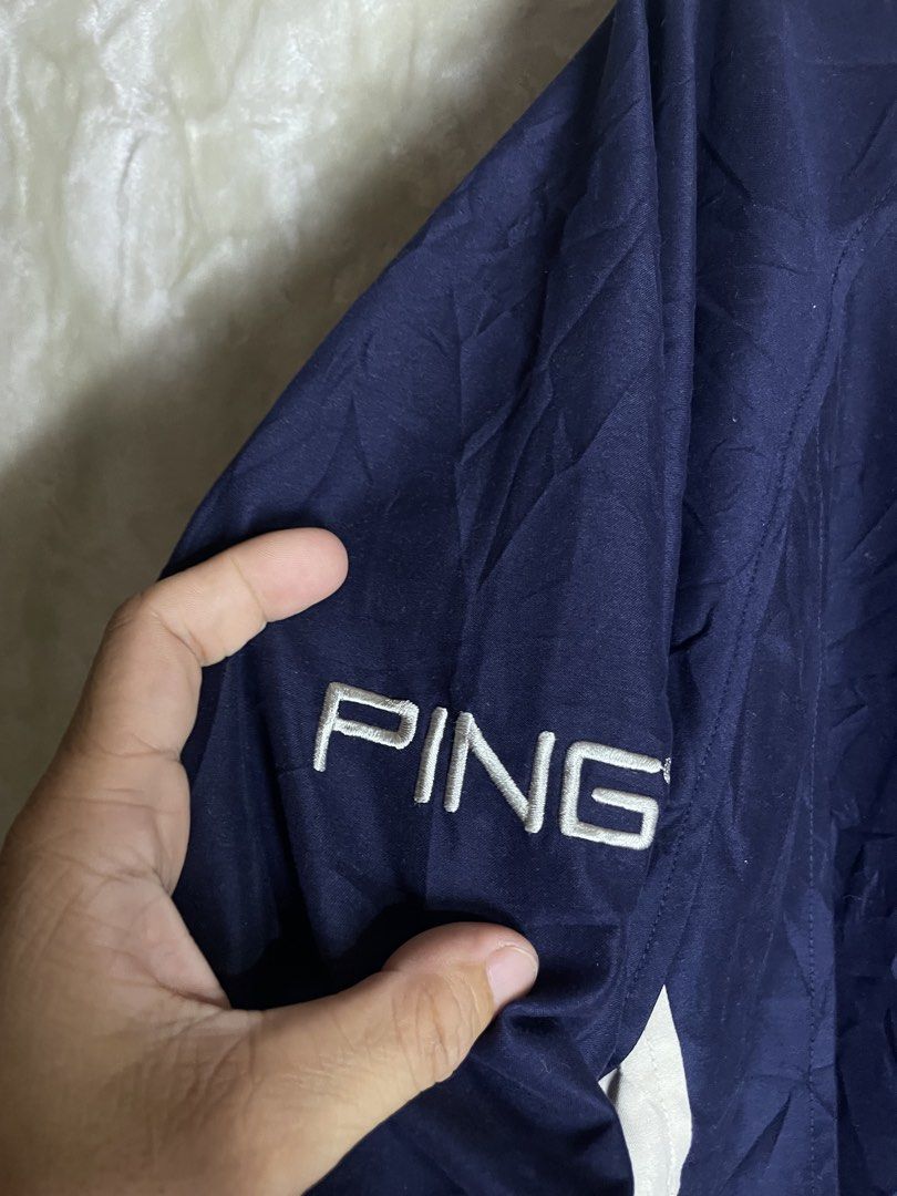 Ping Collection Navy Blue Windbreaker Jacket Size M (Category: Coats, Jackets and Outerwear) located in Molave. Submitted by charlesthrifter (Listing ID 1464895784, Image 3). Description: - Brand: Ping Collection - Color: Navy blue with white collar and side panel details - Size: Medium (M) - Material: 100% polyester shell (lightweight) - Features: Half-zip front closure with branded zipper pull and embroidered logo on the right sleeve - Ideal fo
