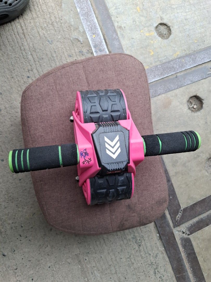 Pink and Black Ab Roller Wheel for Core Workout (Category: Toning & Stretching Accessories) located in Manila. Submitted by rocksolid227 (Listing ID 1464795905, Image 1). Description: - Dual-wheel design with textured rubber tread for extra floor grip - Comfortable black and green foam handles for planks and rollouts - Sturdy pink frame built for regular home workouts - Great fitness tool for strengthening abs and upper body.