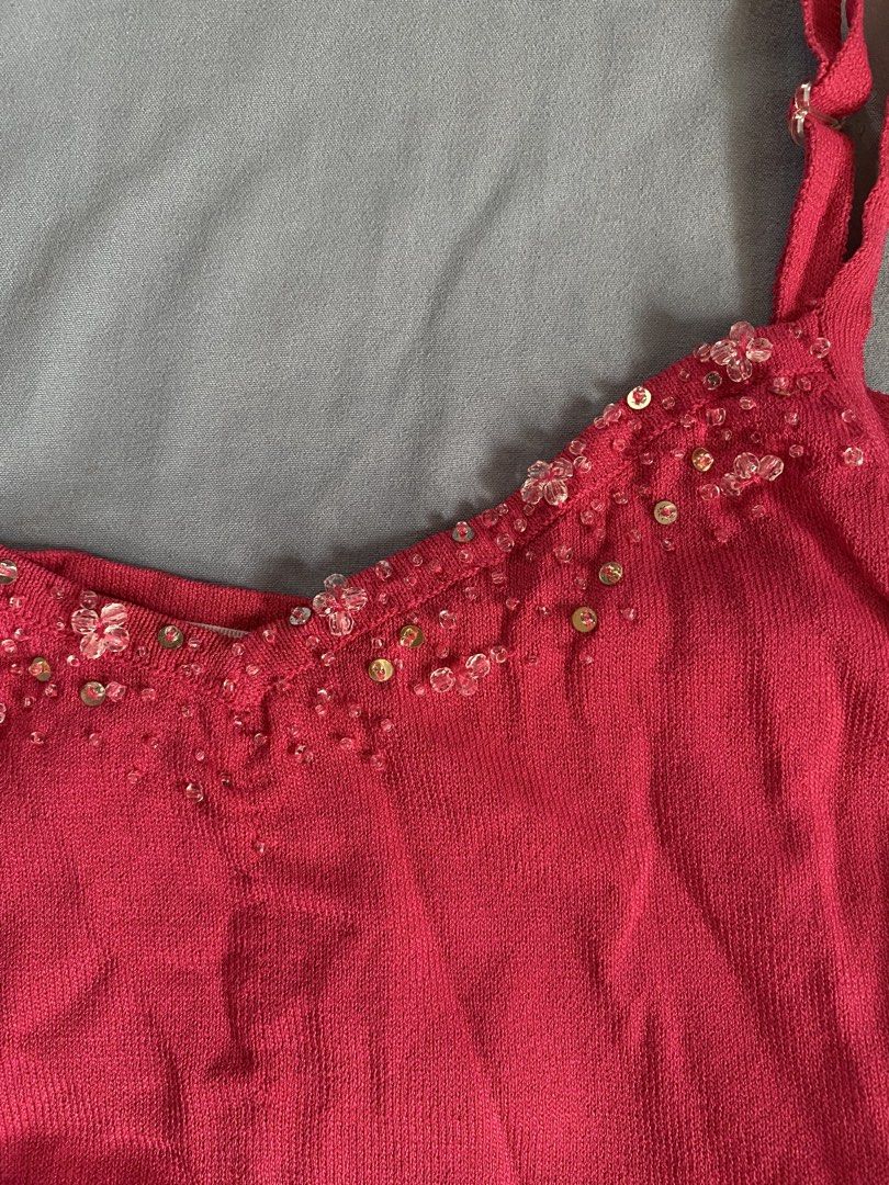 Pink Cami Tank Top with Beaded Neckline (Category: Sleeveless) located in Manila. Submitted by heyheyruok (Listing ID 1464798255, Image 2). Description: - Color: Bright pink - Material: Soft, stretchy ribbed knit - Features: Adjustable straps, sweetheart neckline with beaded and sequin flower/gold disc embellishments - Styling: Perfect to pair with high-waisted jeans or a skirt for a night out.