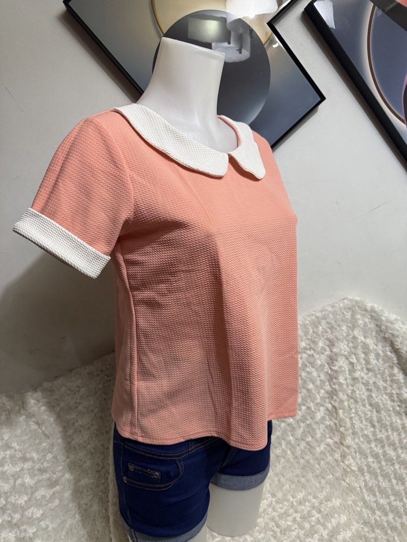 Pink Peter Pan Collar Short Sleeve Blouse (Category: Blouses) located in Marikina City. Submitted by lorradel (Listing ID 1464897552, Image 2). Description: - Color: Pink with white contrast - Style: Short sleeve textured blouse with Peter Pan collar and matching cuffs - Fit: Regular fit, round neckline - Condition: Brand new / Excellent - Versatility: Perfect for casual outings or office workwear - MAY HAVE some washable stains (hindi maiiwasan)