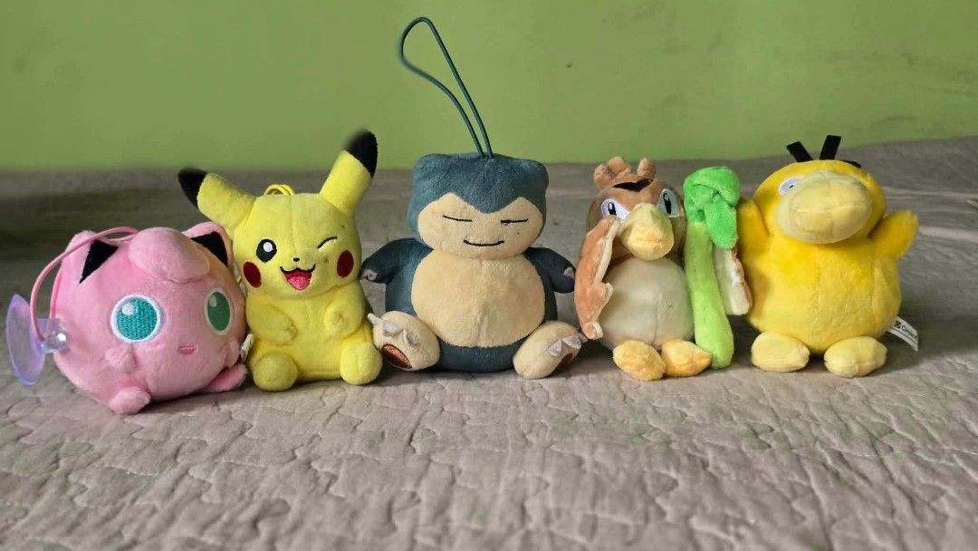 Pokemon Plush Toy Set Jigglypuff Pikachu Snorlax Farfetch'd Psyduck (Category: Plushies & Soft Toys) located in Baguio. Submitted by je_ver_lyn16 (Listing ID 1464845310, Image 1). Description: - Authentic 5-piece Pokémon plush bundle - Includes: Jigglypuff (with suction cup/strap), winking Pikachu, sleeping Snorlax (with loop), Farfetch'd with leek, and Psyduck - Features various fun sizes and poses - Some plushies come with attached straps, loop