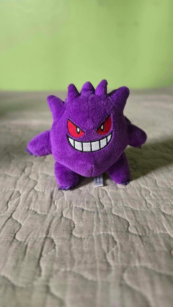 Pokémon Gengar plush keychain purple (Category: Plushies & Soft Toys) located in Baguio. Submitted by je_ver_lyn16 (Listing ID 1464843598, Image 1). Description: - Item: Gengar plush keychain 3rd round korea exclusive - Material: Soft purple fabric with embroidered red eyes and stitched white grin - Attachment: Durable purple plastic clip on the back - Authenticity/Origin: Tag reads '3rd Round Made in China' - Condition: Excellent, clean, no stai