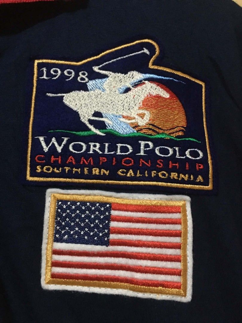 Polo La Martina (Category: Tshirts & Polo Shirts ) located in Davao. Submitted by jepjep23_03 (Listing ID 1464881452, Image 3). Description: - Color: Navy blue with red collar and red-white sleeve blocks - Design: Large number 4, 'U.S.A.' lettering, World Polo Championship 1998 Southern California patch, and American flag detail - Style: Classic button placket, bold 1998 collection graphic style - Condition: Good vintage condition - Perfect for: 