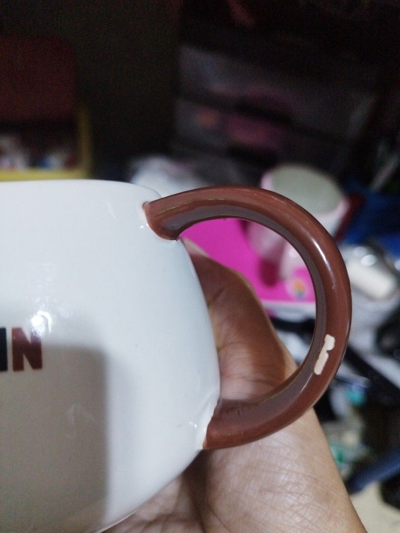 Pompompurin Character Ceramic Coffee Mug (Category: Coffee & Tea Tableware) located in Manila. Submitted by silverwhale_cafa21 (Listing ID 1464794666, Image 3). Description: - Official Pompompurin face design in bright yellow - Unique brown beret shaped as part of the rim - Standard size, perfect for morning coffee or tea - Cute printed facial details - Flaw: Small paint chip near the bottom curve of the brown handle.