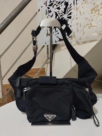Prada Black Nylon Crossbody Shoulder Bag (Category: Belt bags, Clutches and Pouches) located in Quezon City. Submitted by luxuriesbymichiika (Listing ID 1464924900, Image 1). Description: - Authentic Prada shoulder bag in classic black nylon - Lightweight and practical size, ideal for daily commutes or travel - Features an adjustable strap and sturdy metal hardware - Front zipped pocket accented with the iconic triangular logo plaque - Secure and