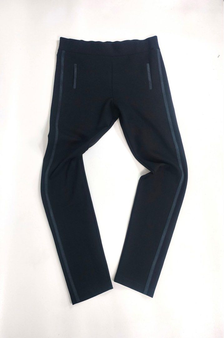 Prada Black Pants Trousers with Side Stripe (Category: Trousers) located in Manila. Submitted by yesterdaysfinds (Listing ID 1464855103, Image 2). Description: Prada Relaxfit Gym Pants Condition : Verygood Size : Large Actual 👇 Waist : 28-32 Lenght : 36 Leg Opening : 8 Insem : 27 Hem : 5 📌 - Brand: Prada - Color: Classic black with contrast side striping - Details: Faux welt pockets and signature metal logo plaque near the waistband - Fit: Clea