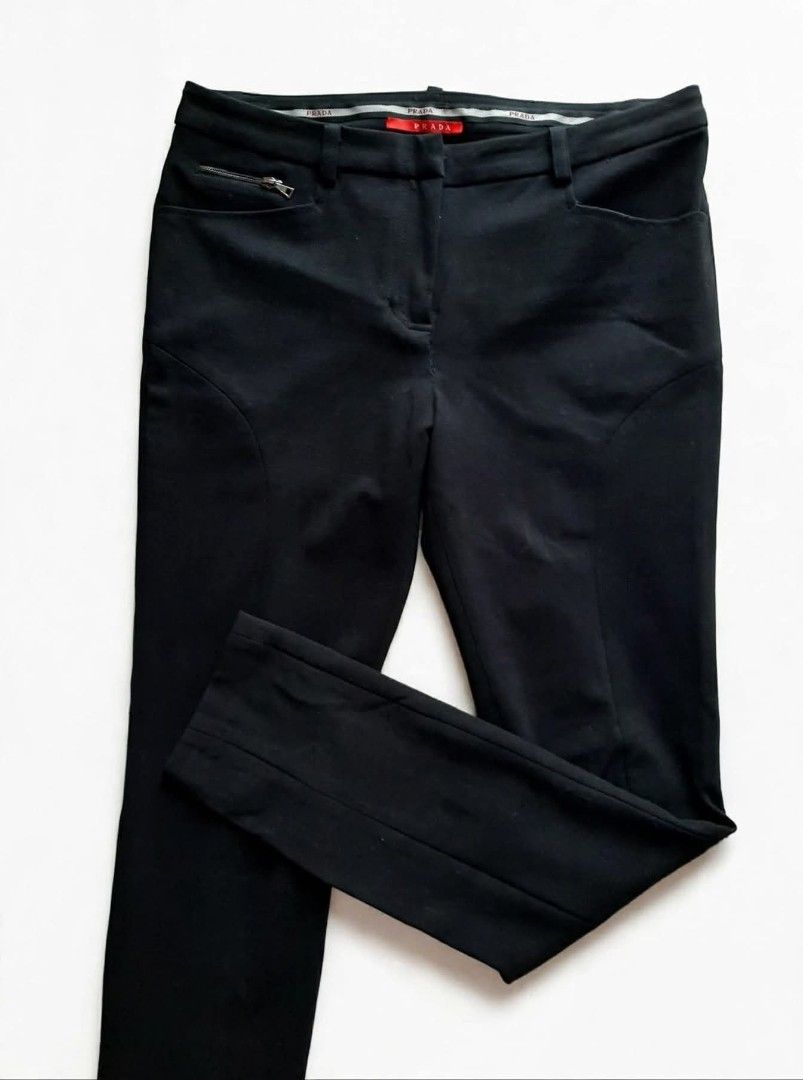 Prada Black Technical Pants (Category: Jeans) located in Aborlan. Submitted by mysticstone_a8589f (Listing ID 1464899263, Image 2). Description: - Brand: Prada - Color: Classic Black - Fit: Modern slim cut with stretchy fabric for maximum comfort - Pockets: Secure zipper pockets on both front hips and back - Details: Prada branding printed near the back pocket and embroidered inside the waistband - Authenticity: Features iconic red Prada fabric t