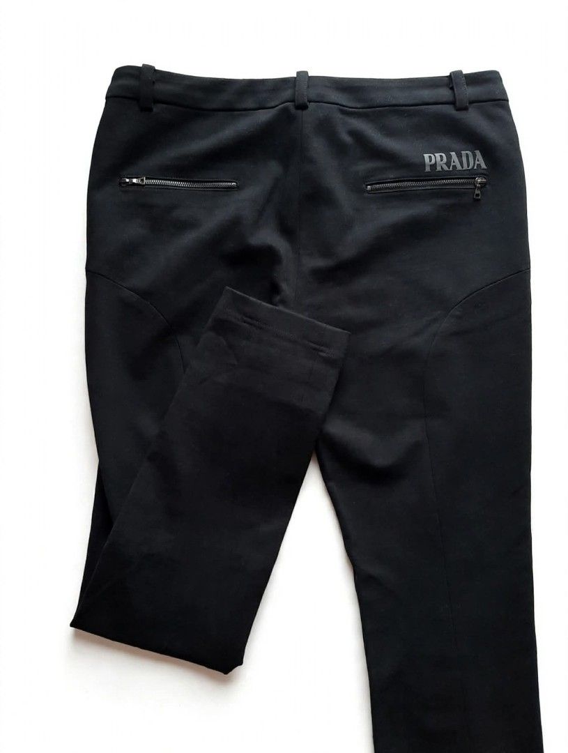 Prada Black Technical Pants (Category: Jeans) located in Aborlan. Submitted by mysticstone_a8589f (Listing ID 1464899263, Image 1). Description: - Brand: Prada - Color: Classic Black - Fit: Modern slim cut with stretchy fabric for maximum comfort - Pockets: Secure zipper pockets on both front hips and back - Details: Prada branding printed near the back pocket and embroidered inside the waistband - Authenticity: Features iconic red Prada fabric t