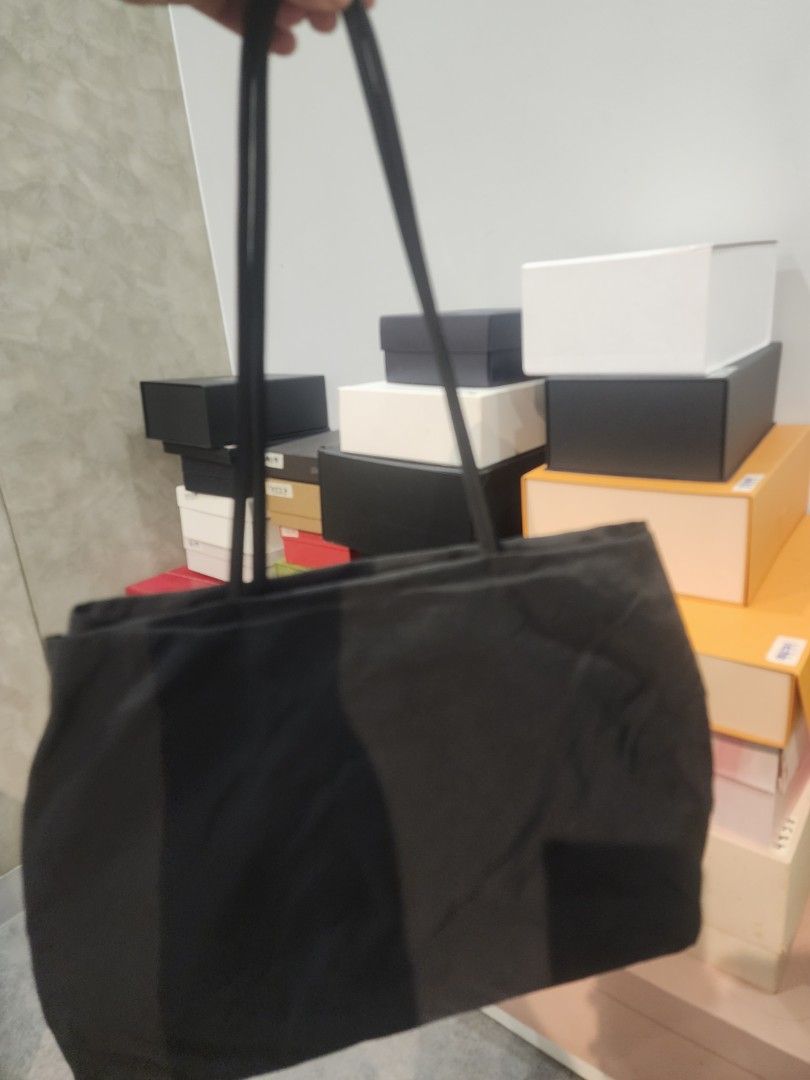 Prada Black Tessuto Nylon Small Tote Bag (Category: Luxury Bags & Wallets) located in Manila. Submitted by justacommoner23 (Listing ID 1464894468, Image 3). Description: - Authentic vintage Prada black nylon small tote from the late '90s / early 2000s - Made of durable black tessuto nylon with sleek leather trim - Double shoulder straps for easy, everyday wear - Features signature black Prada jacquard lining and interior zipper pocket - Classic m