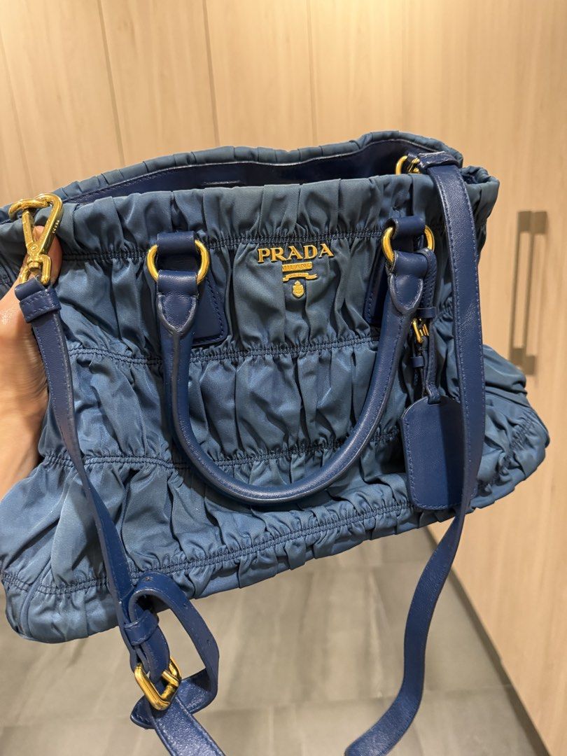 Prada Blue Ruched Nylon Tote Shoulder Bag (Category: Luxury Bags & Wallets) located in Quezon City. Submitted by rey1531 (Listing ID 1464785157, Image 1). Description: - Authentic Prada ruched nylon handbag in a chic blue shade - Elegant gold-tone hardware details - Versatile with double top handles and an adjustable shoulder strap - Includes a matching designer luggage tag - Features a secure zip closure and a structured, stylish shape - Classic