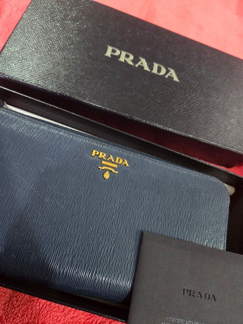 Prada long zip leather wallet (Category: Wallets & Card holders) located in Quezon City. Submitted by jen_4kids (Listing ID 1464868403, Image 1). Description: Prada long zip leather wallet Color (card) bluette Bought jan 2019 Complete inclusion (card, box, paperbag eve receipt) Used less than a year (occasionally) Condition excellent used condition to looks new.