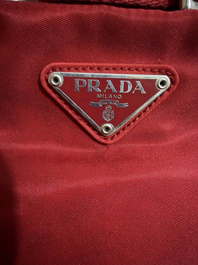 Prada Nylon Sling bag (Category: Luxury Bags & Wallets) located in Muntinlupa City. Submitted by xiez1209 (Listing ID 1464911476, Image 3). Description: Prada Nylon Sling Bag In red color 8.5/10 condition With dustbag and paperbag 15,500 Open for meetup.