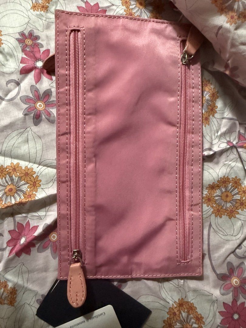 Prada Pink Nylon Pouch with Authenticity Cards (Category: Luxury Bags & Wallets) located in Rizal. Submitted by xsbaggage_ (Listing ID 1464779393, Image 3). Description: - Authentic pink Prada nylon pouch - Dual front zipper compartments with gold-tone hardware - Iconic triangular Prada logo plaque - Gold fabric interior lining with Prada Milano Made in Italy plaque - Includes authenticity certificate cards, product tag, and original black envelo
