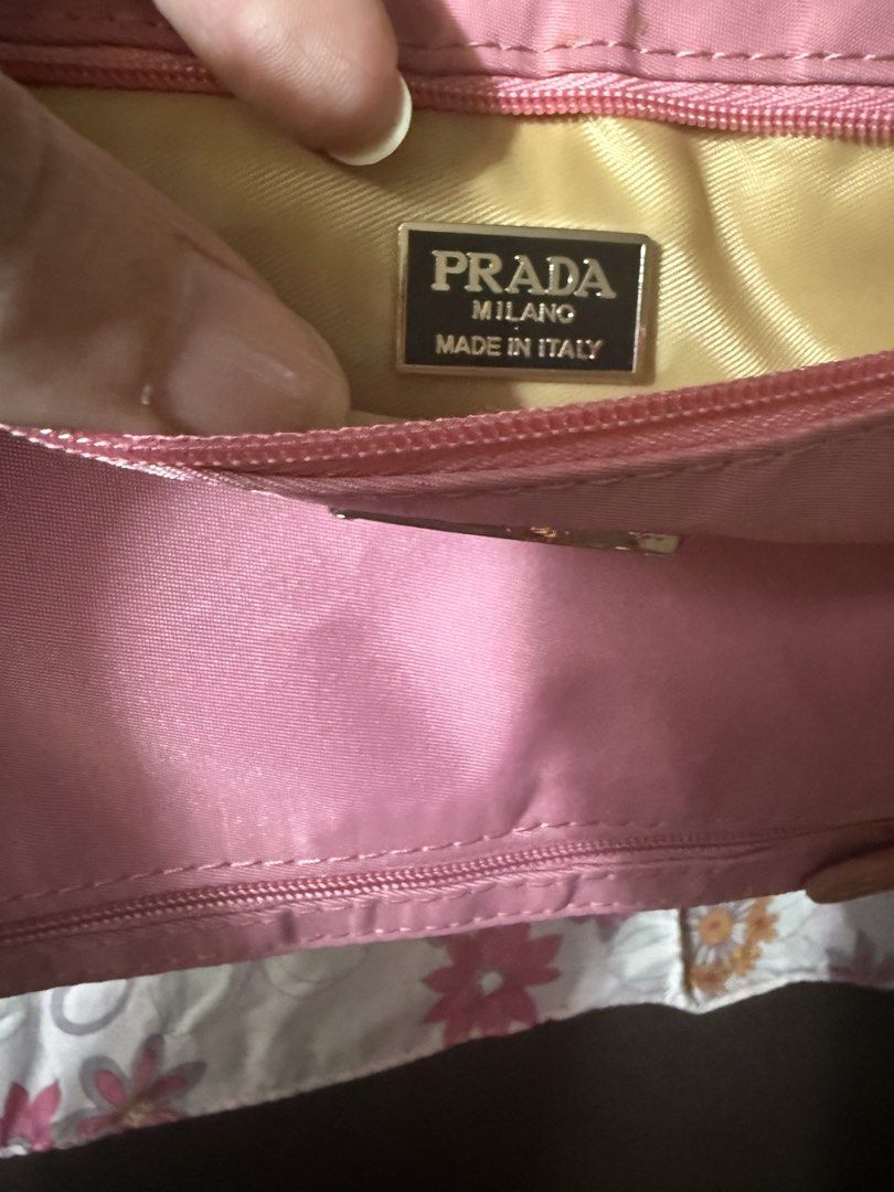 Prada Pink Nylon Pouch with Authenticity Cards (Category: Luxury Bags & Wallets) located in Rizal. Submitted by xsbaggage_ (Listing ID 1464779393, Image 2). Description: - Authentic pink Prada nylon pouch - Dual front zipper compartments with gold-tone hardware - Iconic triangular Prada logo plaque - Gold fabric interior lining with Prada Milano Made in Italy plaque - Includes authenticity certificate cards, product tag, and original black envelo