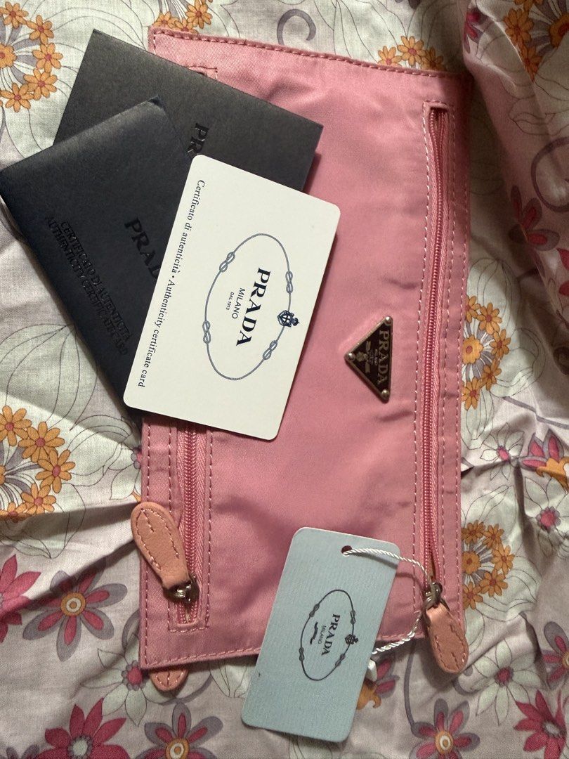 Prada Pink Nylon Pouch with Authenticity Cards (Category: Luxury Bags & Wallets) located in Rizal. Submitted by xsbaggage_ (Listing ID 1464779393, Image 1). Description: - Authentic pink Prada nylon pouch - Dual front zipper compartments with gold-tone hardware - Iconic triangular Prada logo plaque - Gold fabric interior lining with Prada Milano Made in Italy plaque - Includes authenticity certificate cards, product tag, and original black envelo