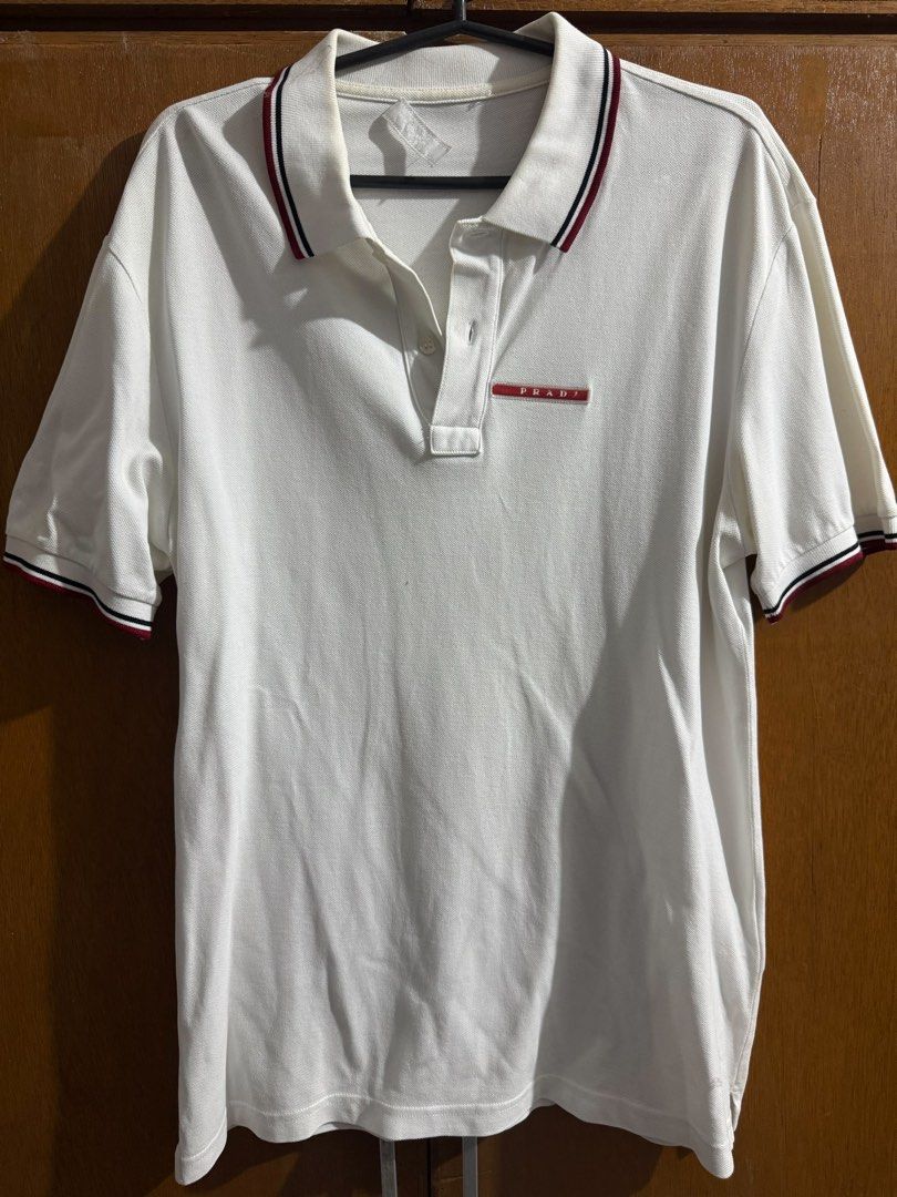Prada Pique (Category: Tshirts & Polo Shirts ) located in Macabebe. Submitted by kurtconcepcion18 (Listing ID 1464788698, Image 2). Description: Prada Size L on tag fits medium Dimes 17x25.5-26 Dark Navy Blue and White Condition 8/10 Issue: Logo on white slightly faded & Slightly cutoff tag Sold as pack 1100 pesos + sf Malolos Bulacan.
