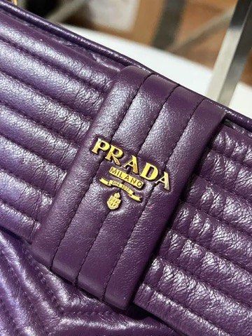 Prada Purple Leather Quilted Bow Shoulder Bag (Category: Purses & Pouches) located in Quezon City. Submitted by luxuriesbymichiika (Listing ID 1464943022, Image 2). Description: - Brand: Prada - Color: Purple - Material: Premium leather with chevron quilting - Hardware: Gold-tone with Prada Milano logo plaque - Closure: Secure zip closure - Features: Cute front bow detail and removable strap with lobster clasps - Condition: Overall clean with ver