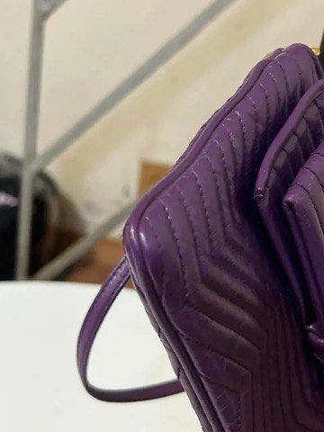 Prada Purple Leather Quilted Bow Shoulder Bag (Category: Purses & Pouches) located in Quezon City. Submitted by luxuriesbymichiika (Listing ID 1464943022, Image 3). Description: - Brand: Prada - Color: Purple - Material: Premium leather with chevron quilting - Hardware: Gold-tone with Prada Milano logo plaque - Closure: Secure zip closure - Features: Cute front bow detail and removable strap with lobster clasps - Condition: Overall clean with ver