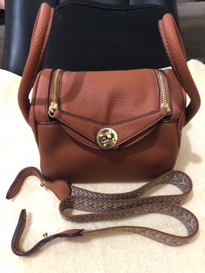 Preloved Hermes Lindy Mini Handbag with 2 straps (Category: Luxury Bags & Wallets) located in Cebu City. Submitted by chem83 (Listing ID 1464824381, Image 1). Description: - Coded but Authenticity is not guaranteed from BKK - Elegant gold-tone hardware with front flap twist-lock closure - Dual structured top handles for hand or arm carry - Includes a trendy, detachable geometric-pattern woven fabric shoulder strap - Convenient dual side zippers f