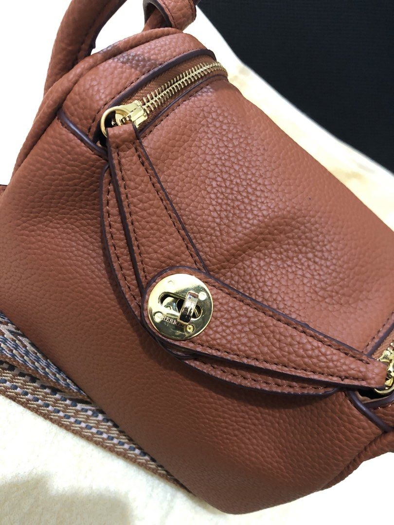 Preloved Hermes Lindy Mini Handbag with 2 straps (Category: Luxury Bags & Wallets) located in Cebu City. Submitted by chem83 (Listing ID 1464824381, Image 3). Description: - Coded but Authenticity is not guaranteed from BKK - Elegant gold-tone hardware with front flap twist-lock closure - Dual structured top handles for hand or arm carry - Includes a trendy, detachable geometric-pattern woven fabric shoulder strap - Convenient dual side zippers f