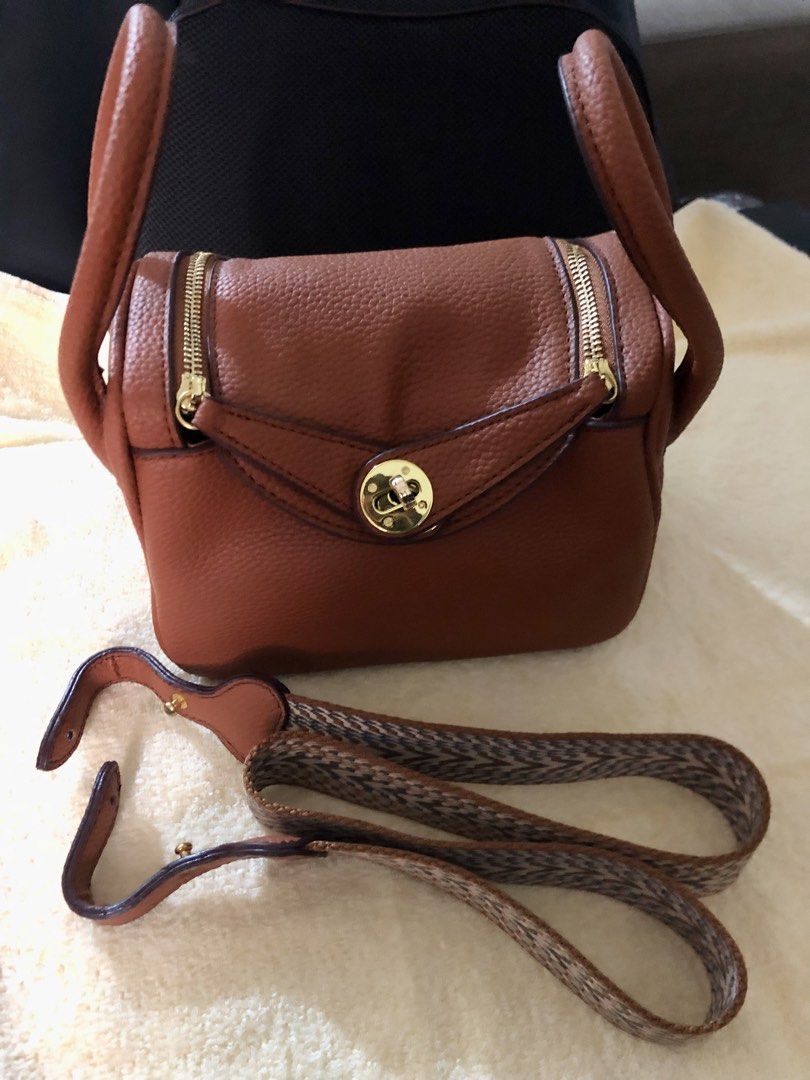 Preloved Hermes Lindy Mini Handbag with 2 straps (Category: Luxury Bags & Wallets) located in Cebu City. Submitted by chem83 (Listing ID 1464824381, Image 2). Description: - Coded but Authenticity is not guaranteed from BKK - Elegant gold-tone hardware with front flap twist-lock closure - Dual structured top handles for hand or arm carry - Includes a trendy, detachable geometric-pattern woven fabric shoulder strap - Convenient dual side zippers f