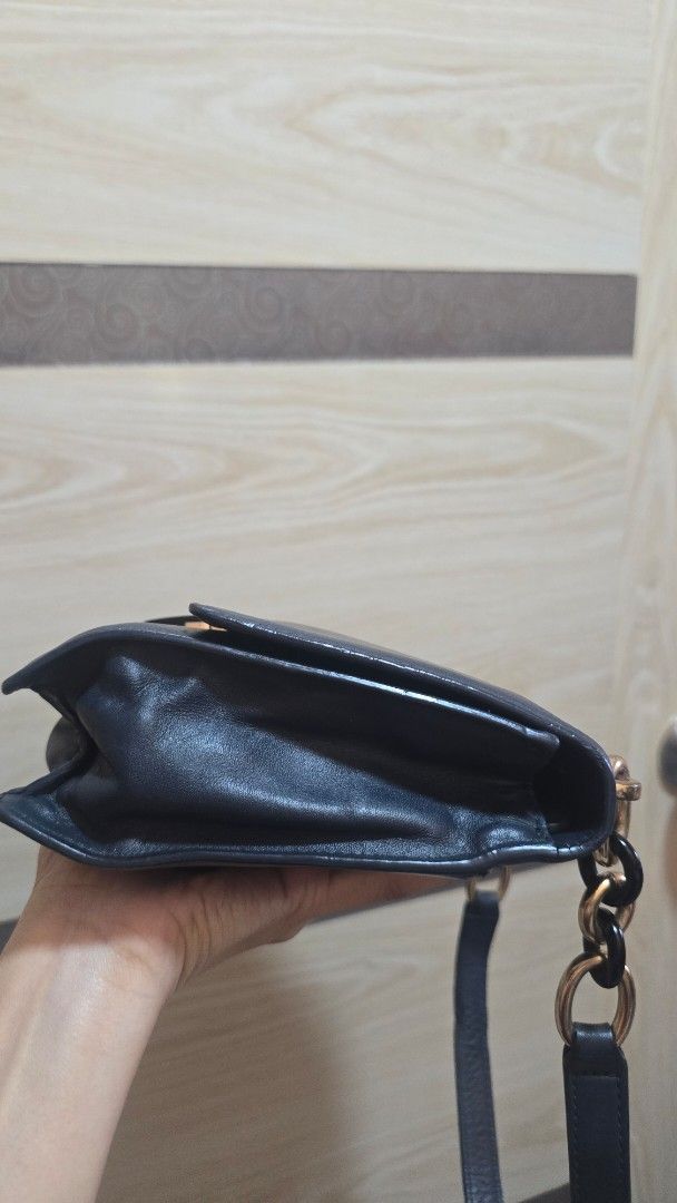 Preloved Michael Kors Leather Shoulder Bag with Chain Strap (Category: Luxury Bags & Wallets) located in Quezon City. Submitted by mbpreloved65 (Listing ID 1464863865, Image 2). Description: - Brand: Michael Kors - Color/Material: Black leather - Closure: Front flap with gold-tone hardware and dark accent plate - Strap: Unique chain and leather design - Interior: Roomy main compartment - Condition: Normal wear on hardware and leather surface.