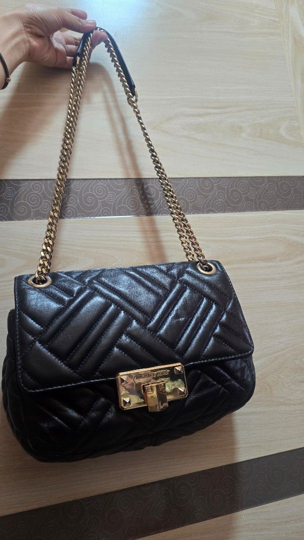 Preloved Michael Kors Quilted Black Leather Shoulder Bag (Category: Luxury Bags & Wallets) located in Quezon City. Submitted by mbpreloved65 (Listing ID 1464863513, Image 1). Description: - Brand: Michael Kors - Material: Black quilted leather with gold hardware - Strap: Elegant gold chain strap - Closure: Secure front flap with turn-lock - Interior: Signature black monogram lining with a convenient zipper pocket - Size: Perfect for carrying dail
