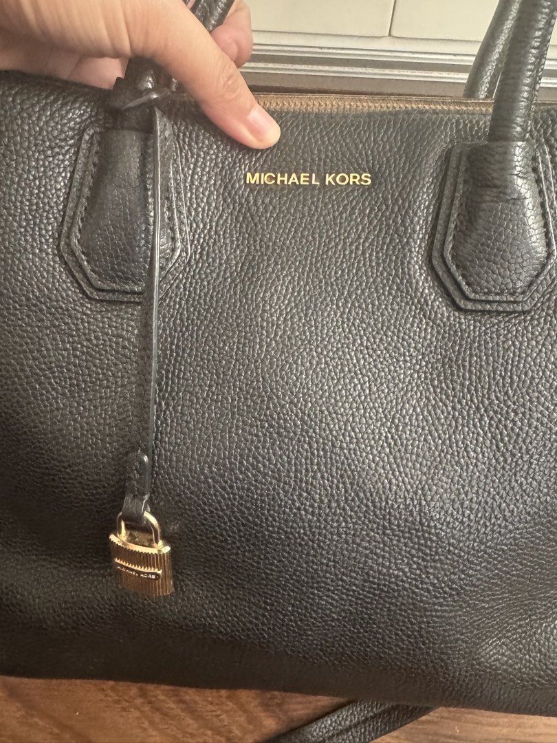 preloved MK Merecer (Category: Luxury Bags & Wallets) located in Rizal. Submitted by thrifty.mom (Listing ID 1464792927, Image 2). Description: Original preloved MK Mercer Black pebble leather satchel from Michael Kors. Gold-tone hardware including a padlock charm on the front. Double top handles and a detachable adjustable shoulder strap. Measures 13in x 10in Minimal flaw sa loob - last photo for reference .