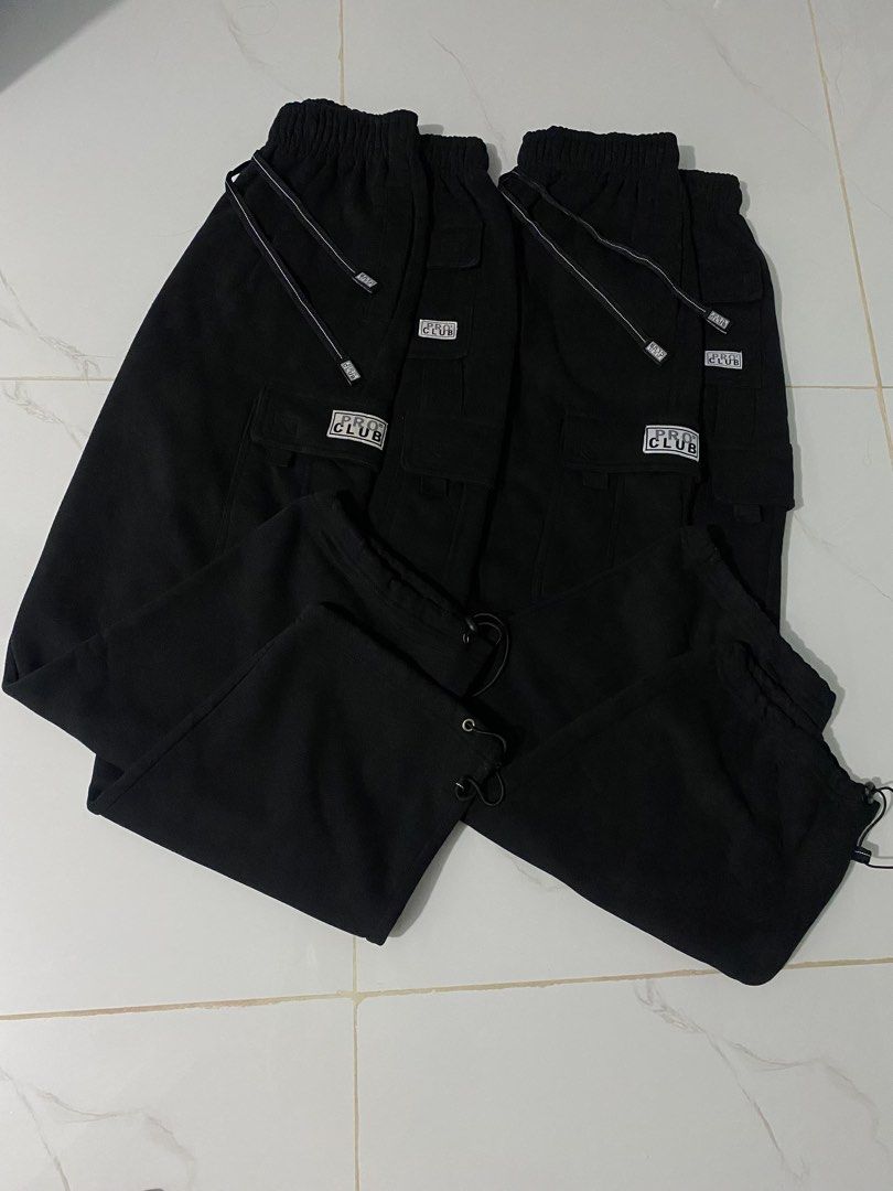 Pro Club Black Cargo Sweatpants with Drawstrings (Category: Joggers) located in Caloocan City. Submitted by mia_thrift911 (Listing ID 1464880664, Image 2). Description: - Brand: Pro Club - Color: Classic Black - Style: Fleece Cargo Sweatpants - Features: Thick, warm material, elastic waistband with adjustable drawstrings, cargo pockets with logo patch, and adjustable bungee cord ankles - Vibe: Ultimate streetwear staple, super comfortable for dai