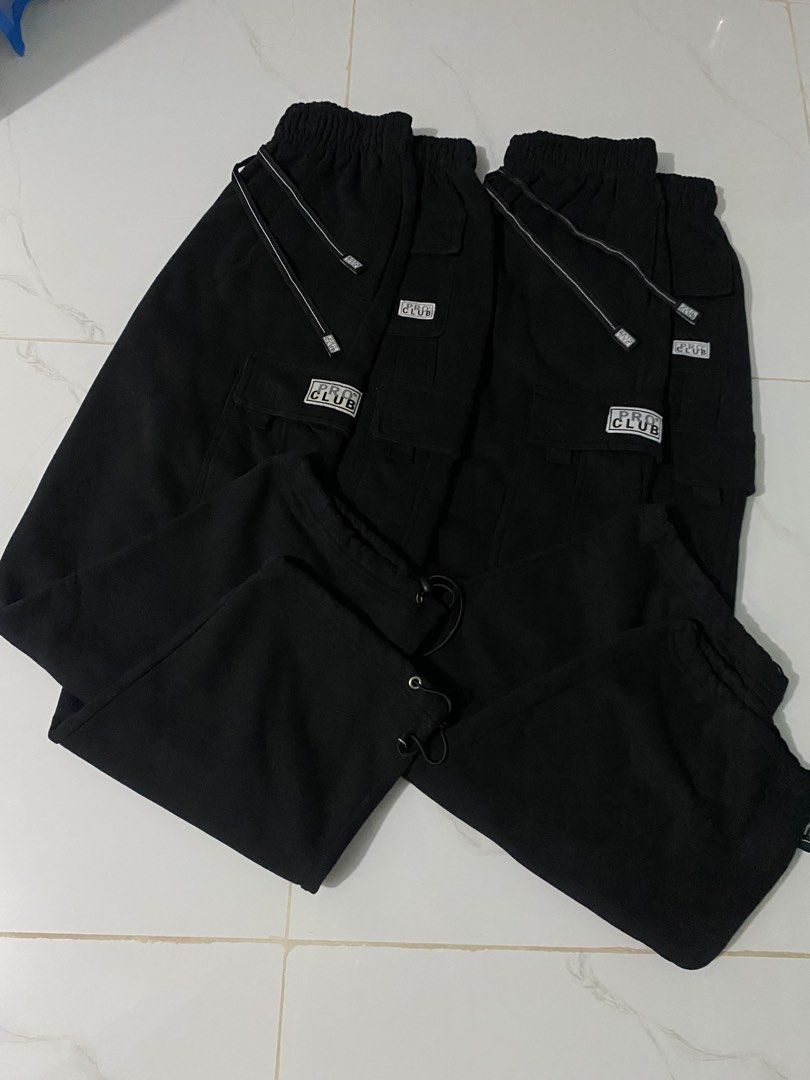 Pro Club Black Cargo Sweatpants with Drawstrings (Category: Joggers) located in Caloocan City. Submitted by mia_thrift911 (Listing ID 1464880664, Image 3). Description: - Brand: Pro Club - Color: Classic Black - Style: Fleece Cargo Sweatpants - Features: Thick, warm material, elastic waistband with adjustable drawstrings, cargo pockets with logo patch, and adjustable bungee cord ankles - Vibe: Ultimate streetwear staple, super comfortable for dai