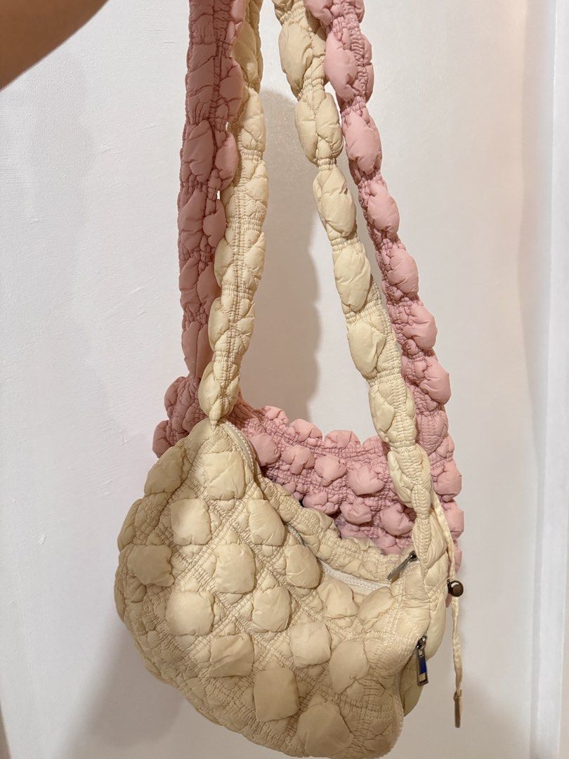 Puffer Cloud Shoulder/Sling Bag Pink and Cream Set (Bundle) (Category: Shoulder Bags) located in Muntinlupa City. Submitted by mimitatsboutique (Listing ID 1464831998, Image 2). Description: - Set of 2 premium quality puffer shoulder/sling bags (Pastel Pink & Cream) - Bought in HKG - Trendy quilted fabric with all-over textured puffy dots - Secure top zipper closure - Stylish long braided strap design - Soft, lightweight, and comfortable to carry