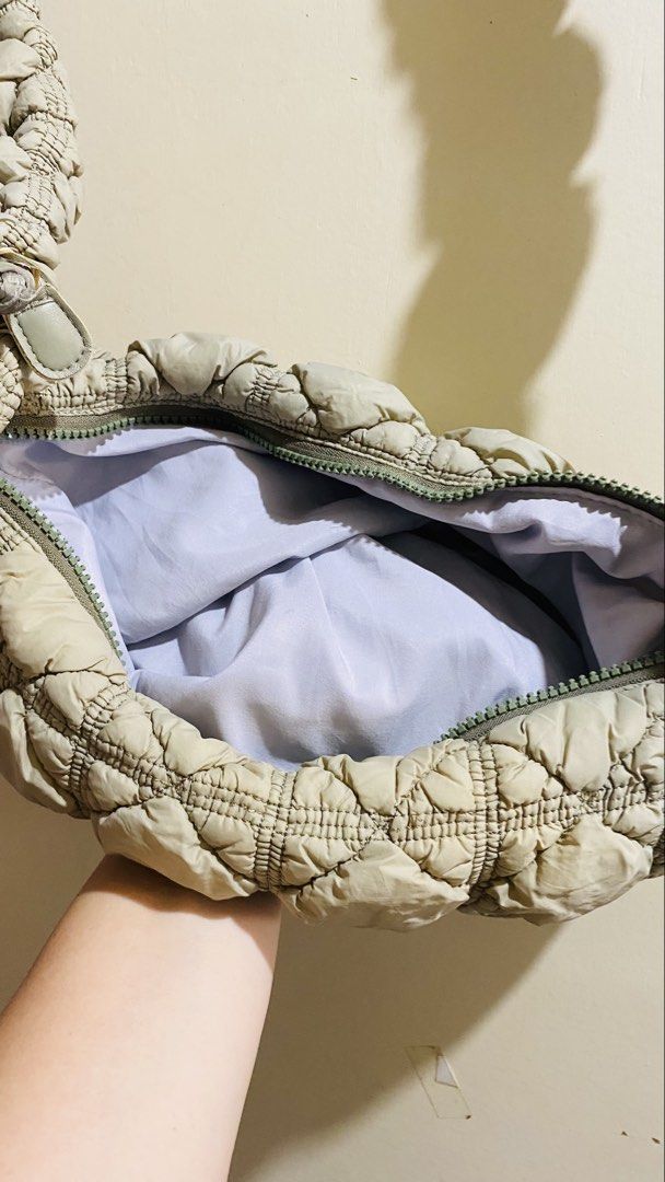 Puffer Quilted Shoulder Bag Grey Beige (Category: Shoulder Bags) located in Santiago. Submitted by kjuvieann39 (Listing ID 1464803229, Image 2). Description: - Color: Neutral grey-beige - Material: Soft crinkled quilted fabric with matching gathered strap - Closure: Secure top zip - Interior: Light purple lining with plenty of room for daily essentials - Style: Lightweight, casual, and trendy everyday carryall - Condition: used sling bag can also