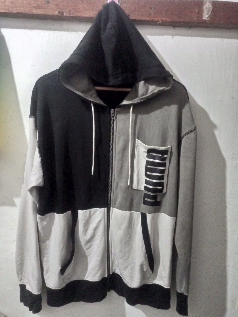 Puma Colorblock Zip-Up Hoodie (Category: Coats, Jackets and Outerwear) located in Manila. Submitted by oxthrift (Listing ID 1464857295, Image 1). Description: - Stylish Puma hoodie with a cool colorblock design. - Features black, grey, and white panels for a modern look. - Convenient chest pocket with the iconic Puma logo. - Full zipper closure for easy wear. - Attached hood for extra warmth and style. - Ideal for everyday casual outfits..