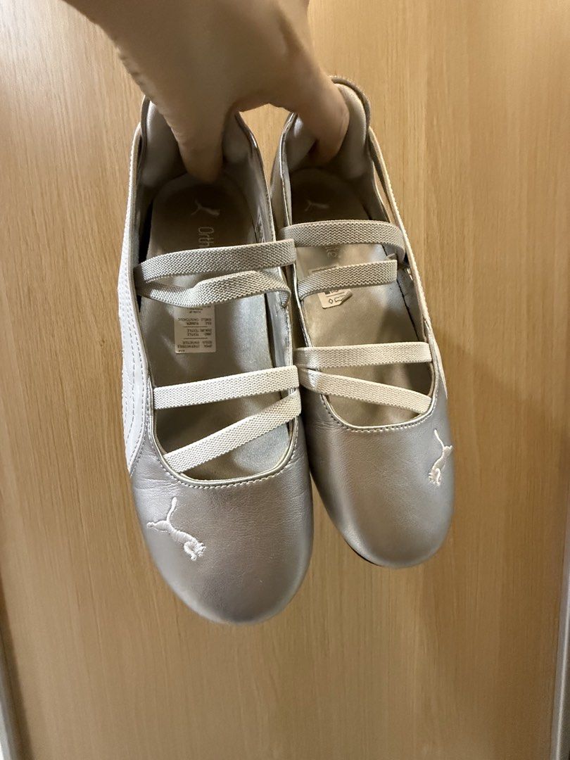 Puma Silver Ballet Sneaker Flats (Category: Sneakers) located in Quezon City. Submitted by magnolianovie (Listing ID 1464805060, Image 1). Description: - Brand/Style: Silver Puma ballet sneaker flats - Comfort: OrthoLite insoles for all-day support - Design: Easy slip-on style with white elastic cross-straps - Details: Signature white Puma formstrip and embroidered toe logo - Size 9.5 - Soles: Dark, durable soles with excellent grip.