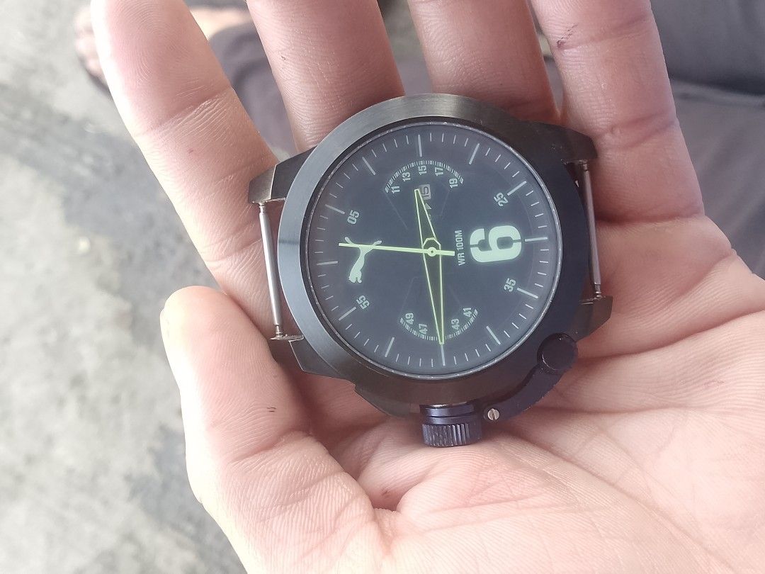 Puma Stainless Steel 805 Watch (Category: Men's Watches) located in Manila. Submitted by epicwind_1bf746 (Listing ID 1464781791, Image 2). Description: - Brand: Puma - Type: Analog watch (Watch head only, strap is missing) - Case Back: Stainless Steel 805 - Water Resistance: 10 ATM / 100 meters - Dial Details: Large '6' marker, small date window near top right, and iconic Puma leaping cat logo on the left - Crown: Positioned at bottom right with 