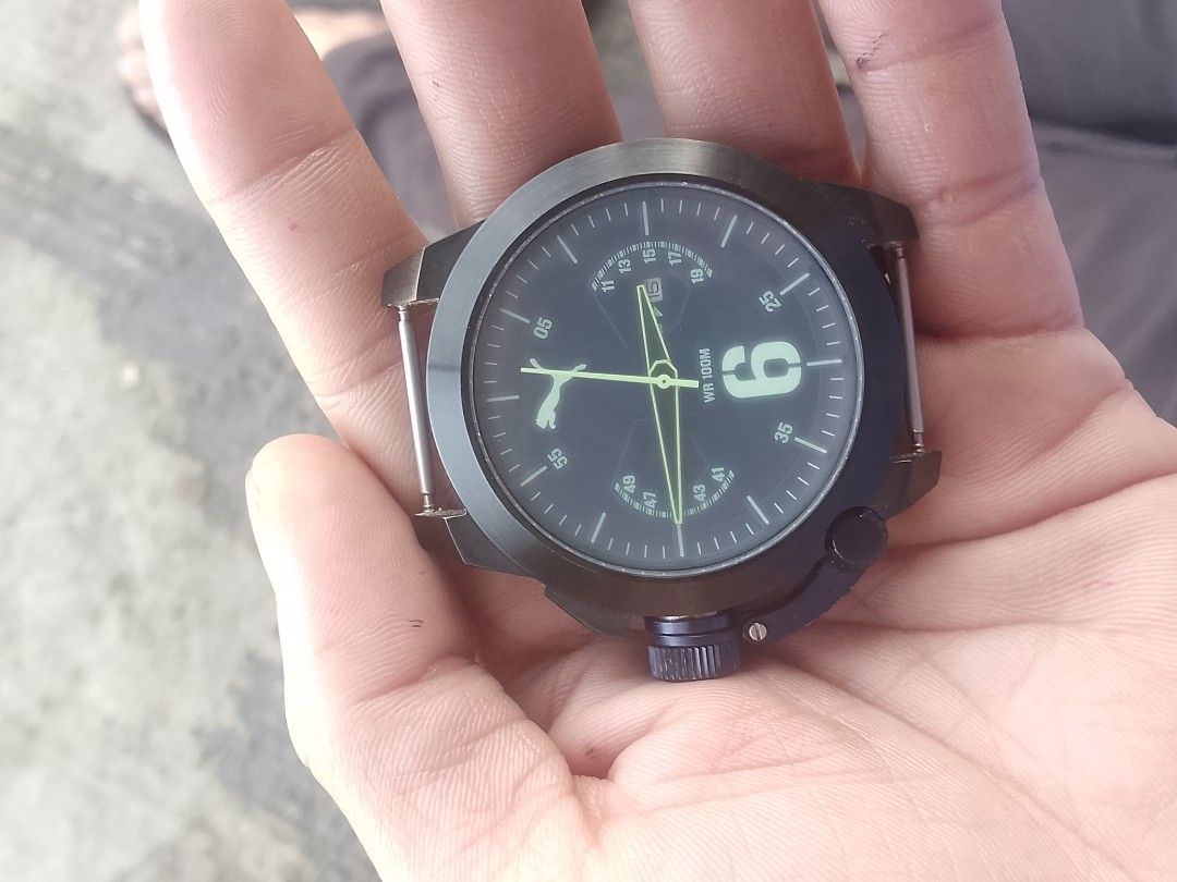 Puma Stainless Steel 805 Watch (Category: Men's Watches) located in Manila. Submitted by epicwind_1bf746 (Listing ID 1464781791, Image 1). Description: - Brand: Puma - Type: Analog watch (Watch head only, strap is missing) - Case Back: Stainless Steel 805 - Water Resistance: 10 ATM / 100 meters - Dial Details: Large '6' marker, small date window near top right, and iconic Puma leaping cat logo on the left - Crown: Positioned at bottom right with 