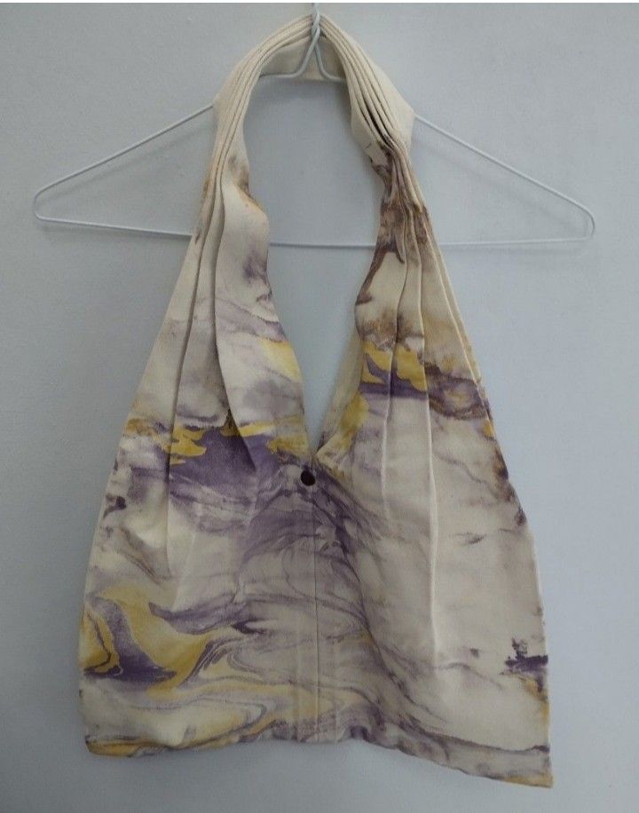 Purple Yellow Marbled Canvas Tote Bag (Category: Tote Bags) located in Mabalacat. Submitted by uniqlover (Listing ID 1464887272, Image 3). Description: - Material: Durable fabric tote bag - Design: Purple and yellow marbled pattern on a neutral off-white base - Closure: Open top with a single bronze-tone button - Details: Structured pleated construction near the handles - Condition: Clean inside and out, with no stains or visible wear.
