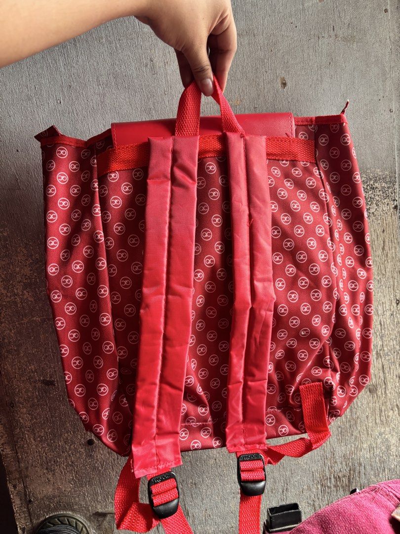 QC Backpack (Category: Backpacks) located in Quezon City. Submitted by lrahc__ (Listing ID 1464798477, Image 2). Description: - Eye-catching red backpack with a repeating QC monogram pattern - Solid red top flap featuring a debossed QC logo and Quezon City emblem button - Convenient front slip pocket located right underneath the flap - Adjustable red shoulder straps for a comfortable, custom fit - Made with durable fabric material built to last f