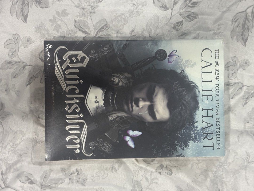 Quicksilver Callie Hart Novel (Category: Storybooks) located in Manila. Submitted by belleshop_authbooks12 (Listing ID 1464889339, Image 1). Description: - Title: Quicksilver by Callie Hart - Status: Brand new, sealed in original plastic wrap - Genre: New York Times Bestseller Fantasy Book - Design: Stunning dark cover art with an armored warrior and purple butterflies - Shipping: Ships securely from a trusted Carousell seller.