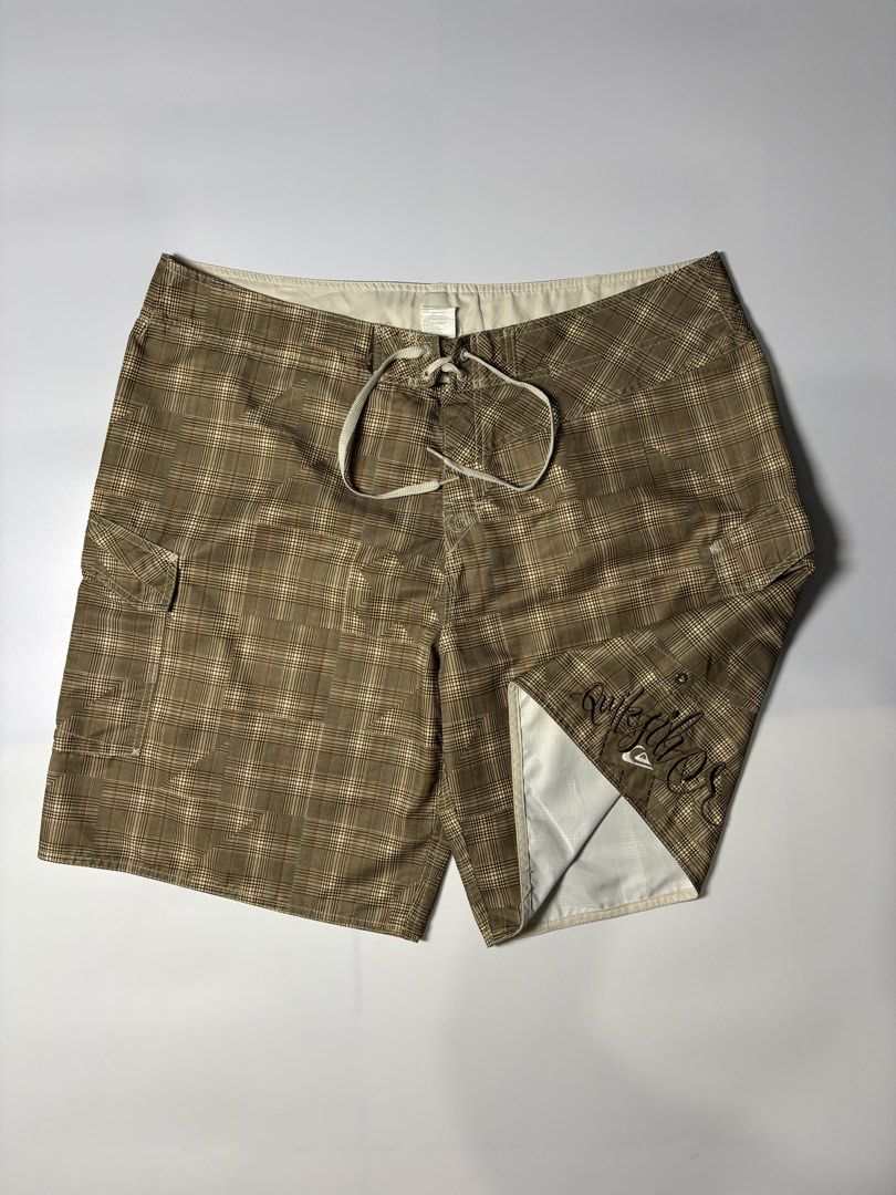 Quiksilver Plaid Board Shorts (Category: Swim Trunks & Board Shorts) located in Cabuyao City. Submitted by macnthrifts. (Listing ID 1464844741, Image 1). Description: - Authentic Quiksilver board shorts - Stylish brown plaid pattern - Secure drawstring waist with metal grommets - Convenient side cargo pocket on the left leg - Features embroidered Quiksilver script branding and logo patch - Classic surf style made with lightweight, comfortable fab