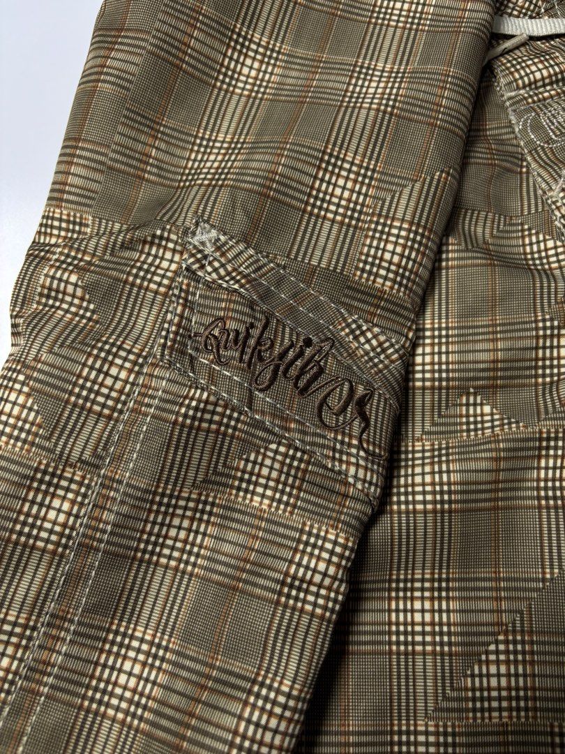 Quiksilver Plaid Board Shorts (Category: Swim Trunks & Board Shorts) located in Cabuyao City. Submitted by macnthrifts. (Listing ID 1464844741, Image 3). Description: - Authentic Quiksilver board shorts - Stylish brown plaid pattern - Secure drawstring waist with metal grommets - Convenient side cargo pocket on the left leg - Features embroidered Quiksilver script branding and logo patch - Classic surf style made with lightweight, comfortable fab