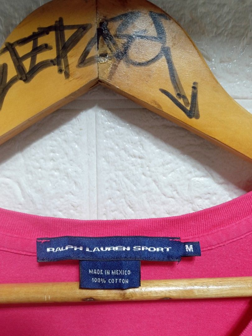 Ralph Lauren (Category: Blouses) located in Danao, Cebu. Submitted by 6000thrifts.ph (Listing ID 1464821822, Image 3). Description: - Brand: Ralph Lauren Sport - Style: V-neck short-sleeve t-shirt - Color: Vibrant Pink with green embroidered logo - Size: Medium (M) - Material: 100% Cotton (Made in Mexico) - Condition: Excellent pre-owned condition, soft and breathable fabric.