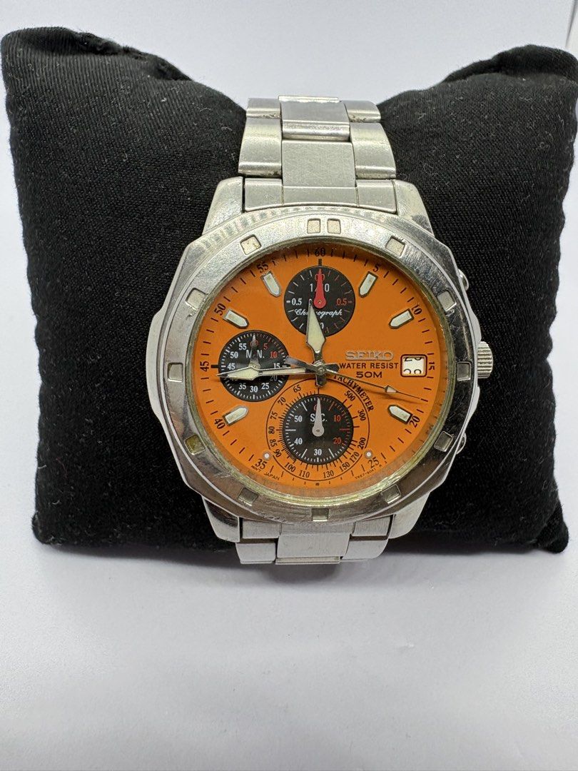 Rare Seiko Chronograph Orange Dial Watch (Category: Men's Watches) located in Quezon City. Submitted by rentoti (Listing ID 1464795572, Image 1). Description: - Brand/Model: Seiko Chronograph - Dial: Vibrant orange with three sub-dials and date window at 3 o'clock - Bezel: Tachymeter bezel - Case & Bracelet: Stainless steel case with matching metal bracelet - Case Back: Engraved with Seiko branding, serial number 831140, and 5 bar water resistanc